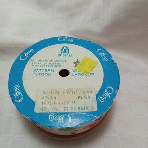 The remaining long length of a roll of vintage ribbon with an Christmas pattern